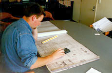 [Studying the plans]